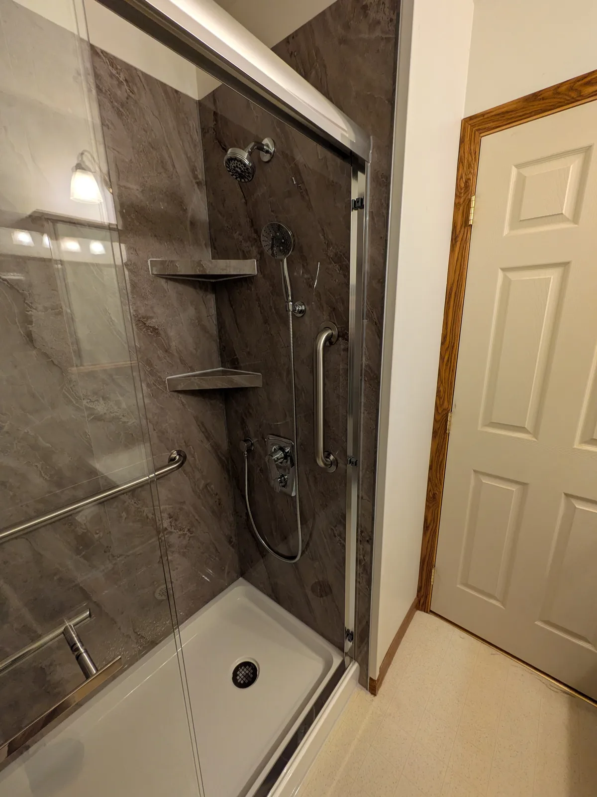 Glass door closed on the completed accessible shower