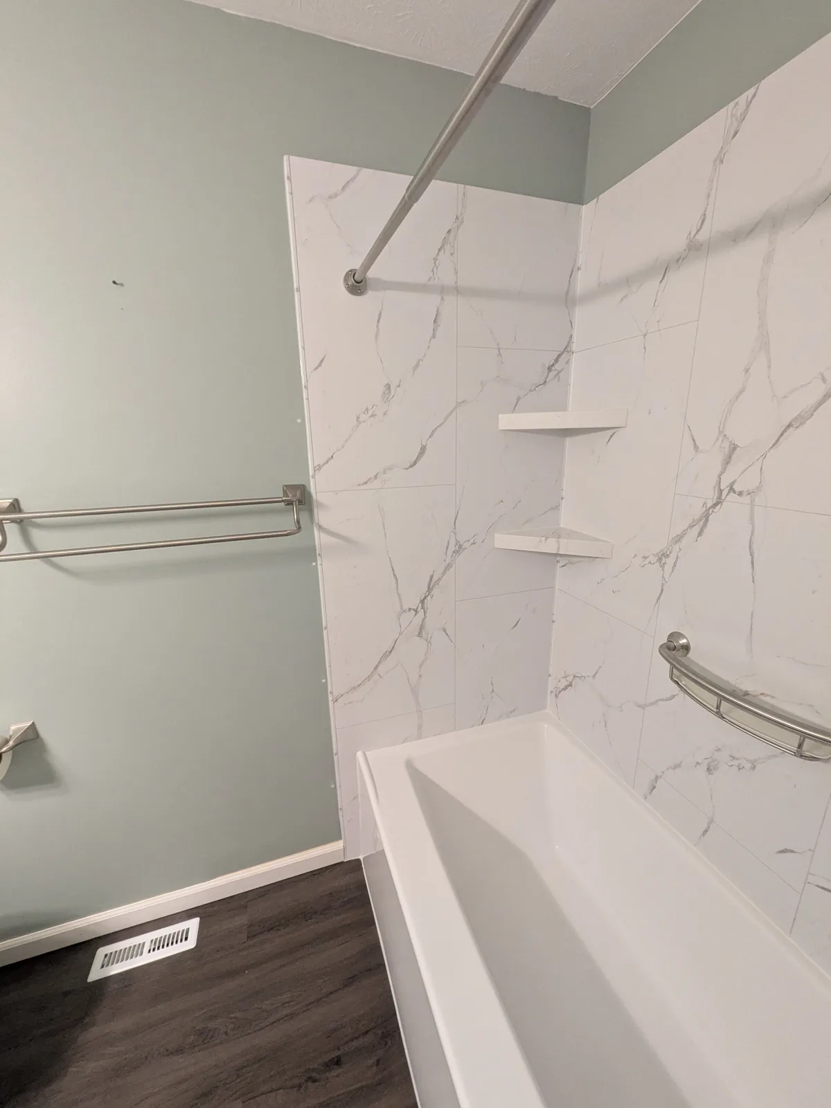 Finished tub alcove with brushed-nickel trim and glass
